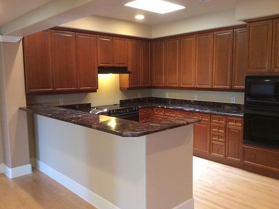Full kitchen with granite slab counters