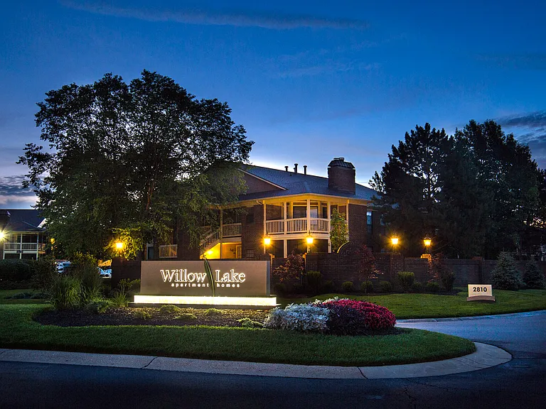 Community entrance sign at dusk