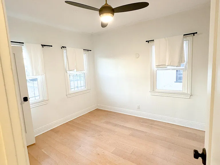 Bedroom with double paned windows and ceiling fan
