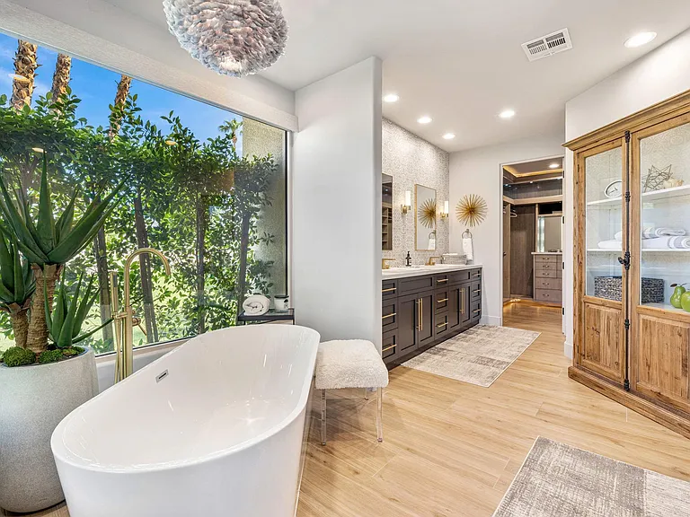 Primary bath with shower, bathtub and his and her walk-in closets