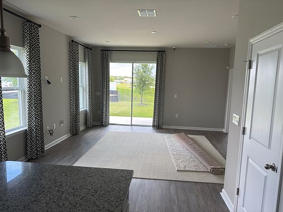 family room, there are two area rugs than can be placed anywhere