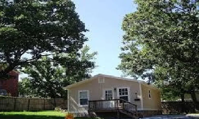 this photo shows the front of the house before it expansion of the front balcony, side deck and pathway with locked gate for security purposes this is an old photo