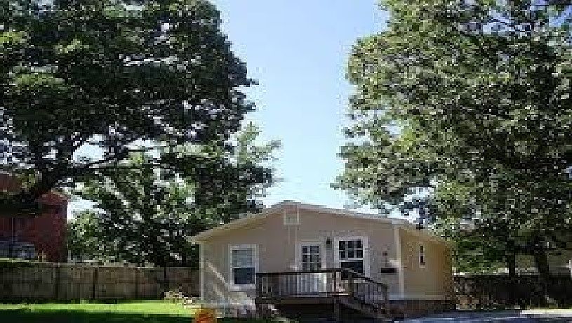 this photo shows the front of the house before it expansion of the front balcony, side deck and pathway with locked gate for security purposes this is an old photo