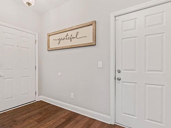 Entry Hallway with half bathroom for guest use. Hooks for jackets and the second entry door to the garage.