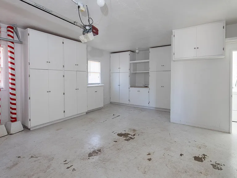 Garage with ample storage room and built in cabinets