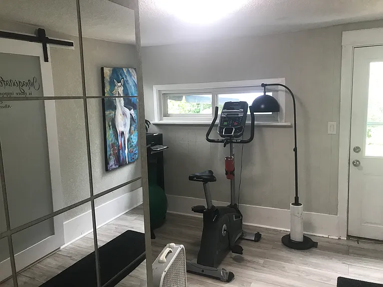 Office and/or workout space; also used as third bedroom. To left is washer-dryer & laundry closet. Door leads to backyard sanctuary.