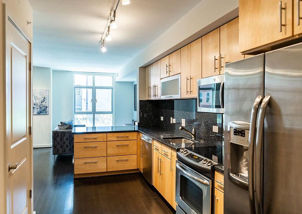 Beautiful, modern kitchen with ample storage, modern appliances, and deep blue pearl granite countertops.