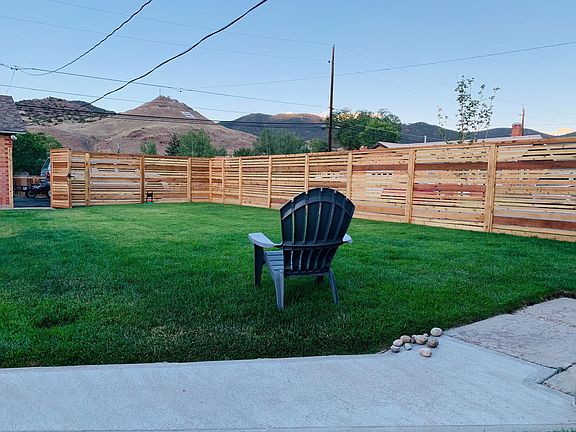 Fenced in yard with view of Tenderfoot Mountain