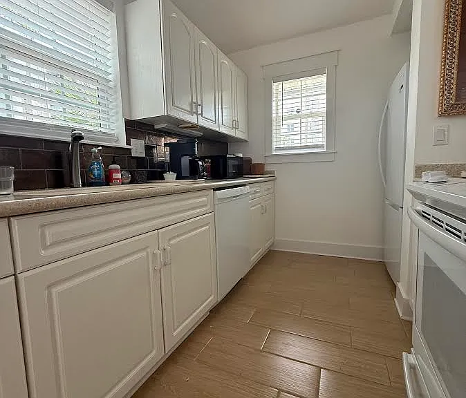 Kitchen is flooded with natural light and has brand new dishwasher and fridge.