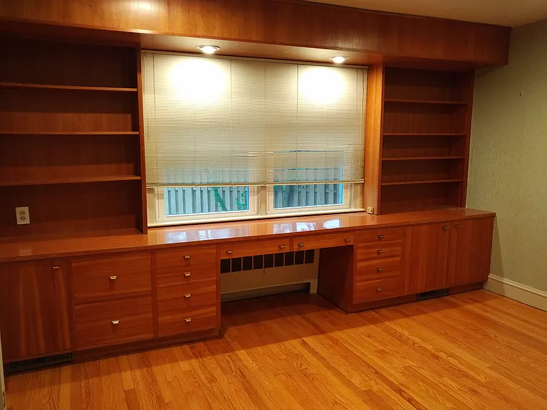 second bedroom with built-in desk, storage and shelves