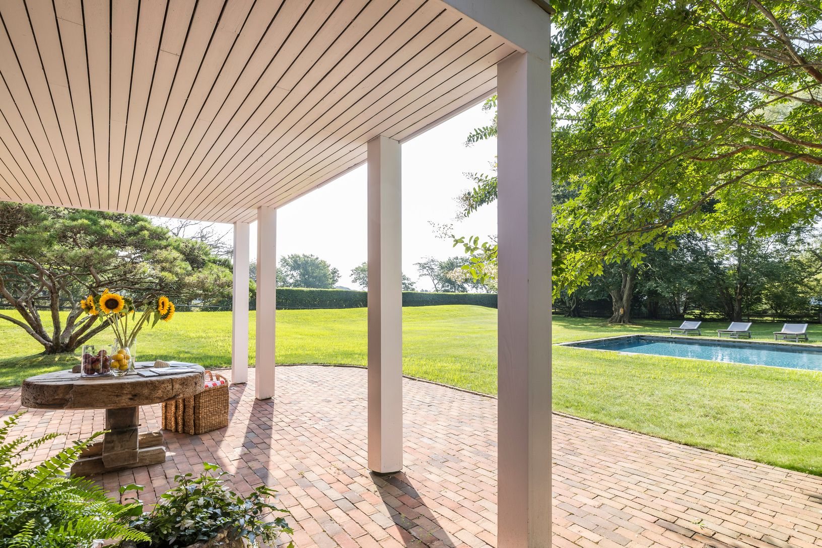  Outdoor Pool flanked by Covered Porch and Patio Area