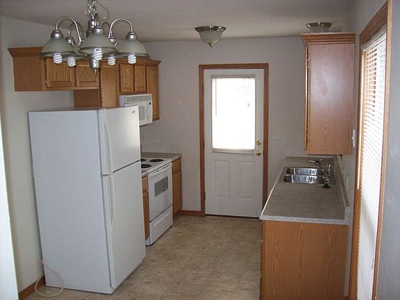 - Kitchen includes Fridge, Stove, Microwave, and Dishwasher
- Back Door to Patio