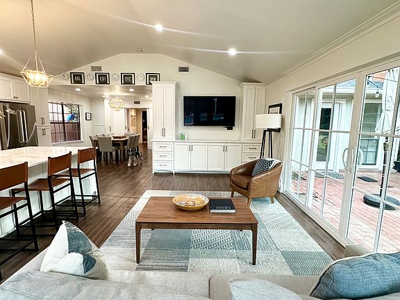 Large entertaining space off kitchen with sliding doors that open to courtyard and pool