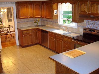 Kitchen features new SS appliances.