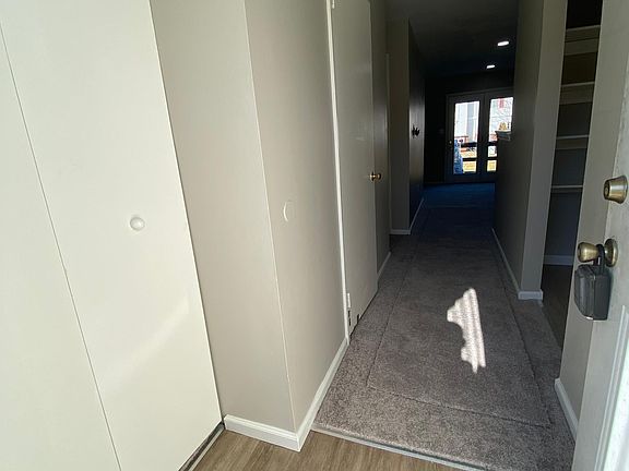 Entry way with luxury vinyl tile, coat closet /storage to the left. Kitchen located towards the right after entry with poweder room on left