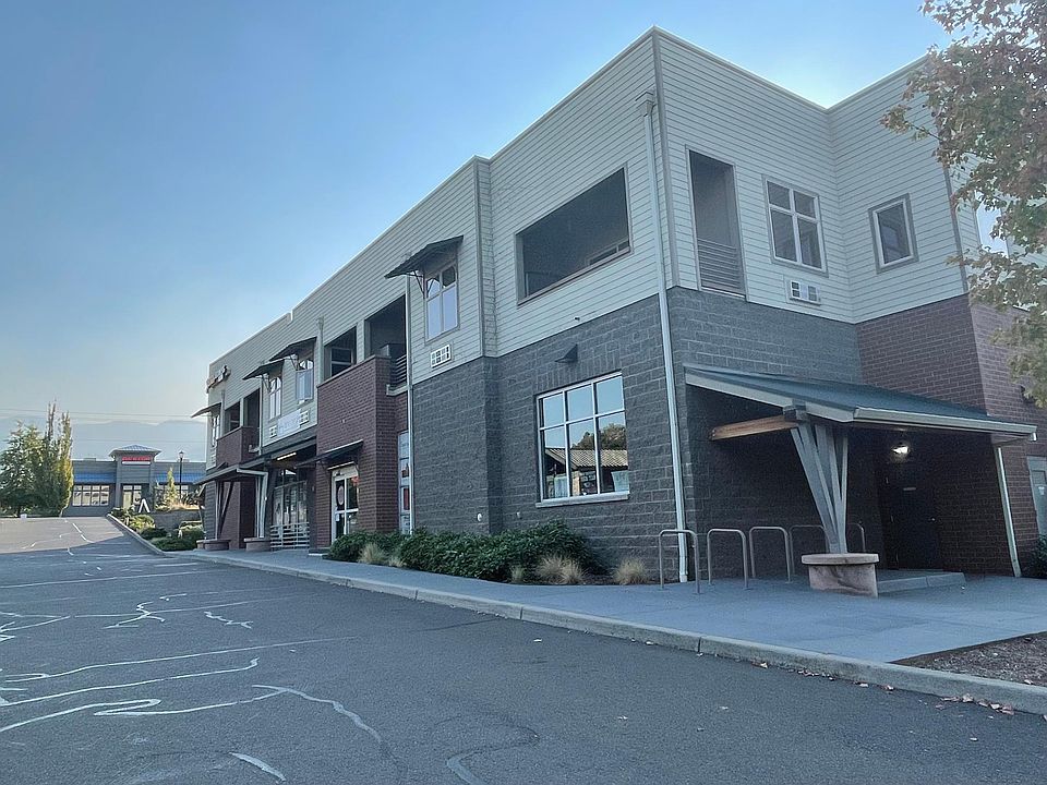 Exterior of the building, with new lighting, paint, new parking lot, updated landscaping.