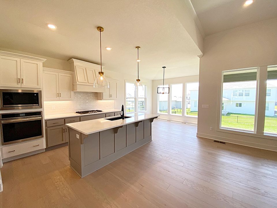 Designer kitchen with gas cooktop, designer tile and upgraded lighting.