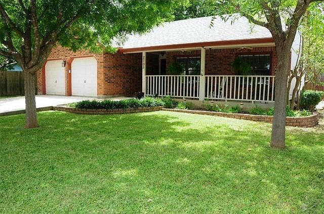 Front view with nice yard and landscaping.