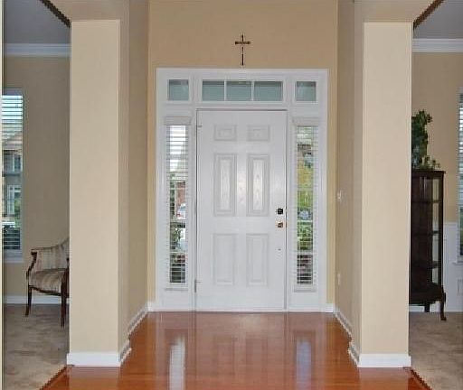 Foyer with soaring ceiling and crown molding