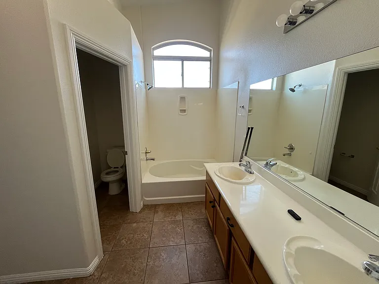 Primary bedroom - bathroom - with private toilet room, tub with shower and dual sinks