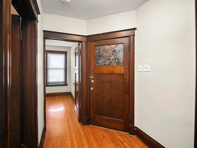 Hallway off breakfast room includes desk/storage space; leads to bathroom, bedroom, laundry, yard