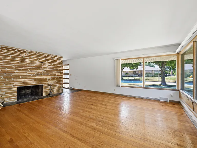 Living Room with Brick Fireplace and Hardwood Floors