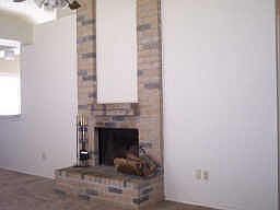Wood burning gas f/p. High ceilings with plant ledges. Open family room with lots of windows.