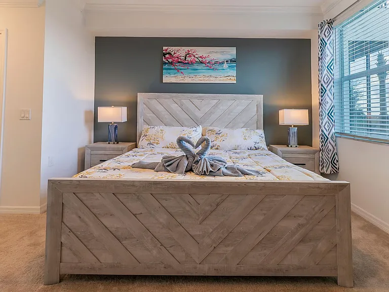 Master bed with nightstands and a touch operated night lights to dim and turn on/off. The window overlooks golfcourse and the lake