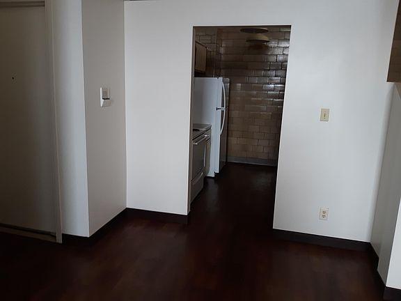 view of kitchen from the living room- original brick walls