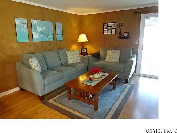 Living Room. Sliding doors lead to three season room and fully fenced yard!