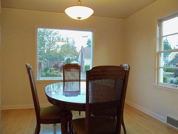 Formal dining room with period light fixture.