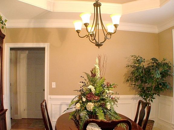 The formal dining room with decorative columns and trey ceiling