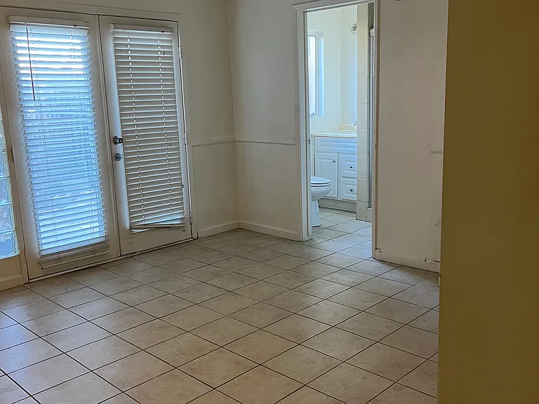 Bedroom with windows to private patio