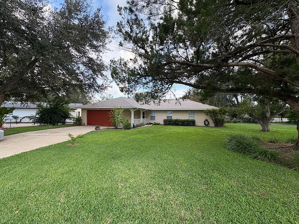 Street view of home showing mature trees, well maintained yard, and new roof.
