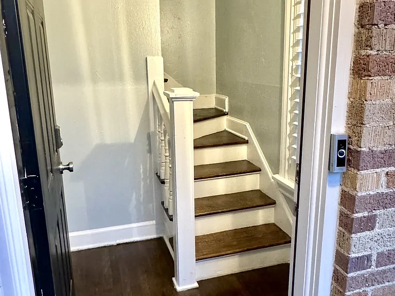 View from the front door entrance showing stairs going up to the unit.