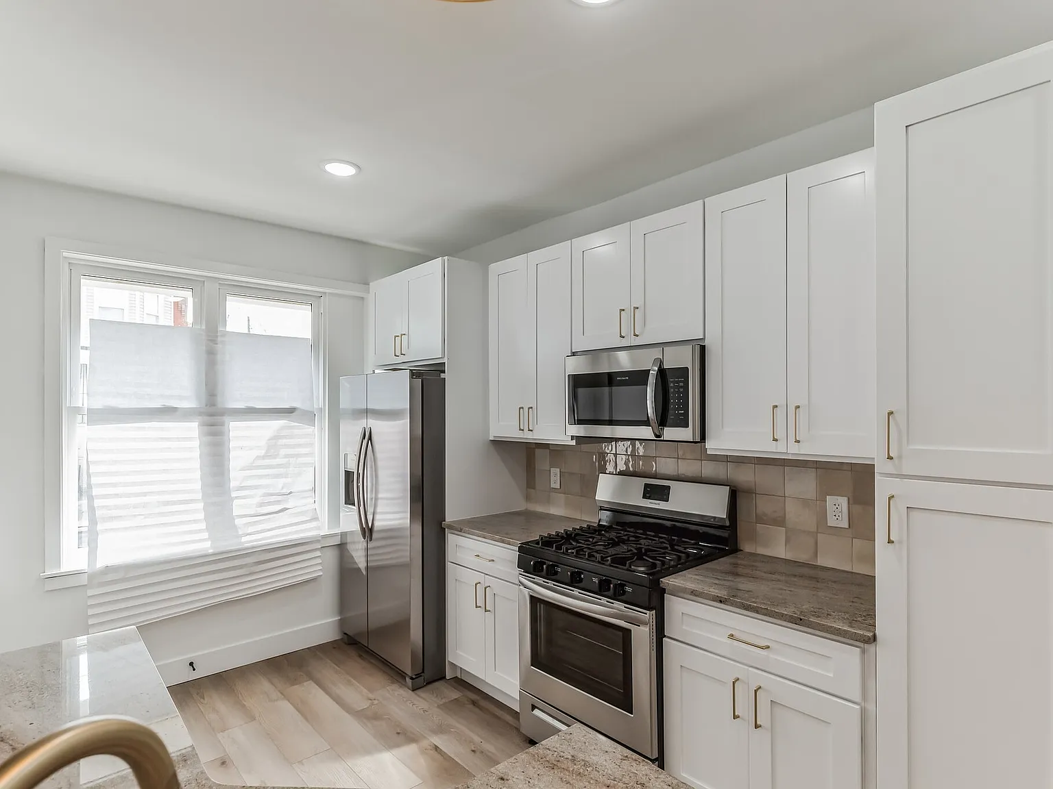 Stylish 2-Bedroom with Finished Basement, Outdoor Space & In-Unit Laundry — Photo 3