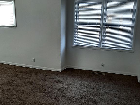 View from living/dining room toward south wall (plastic strip is temporary carpet protection)