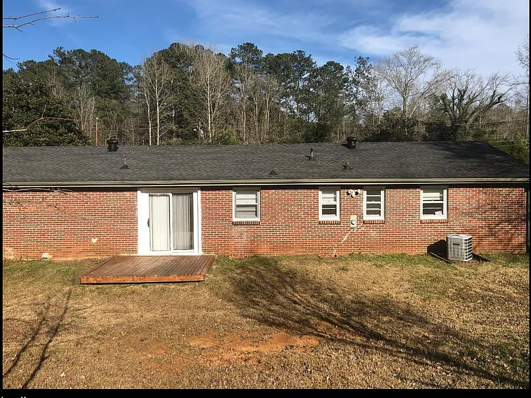 Back view of home with patio deck.