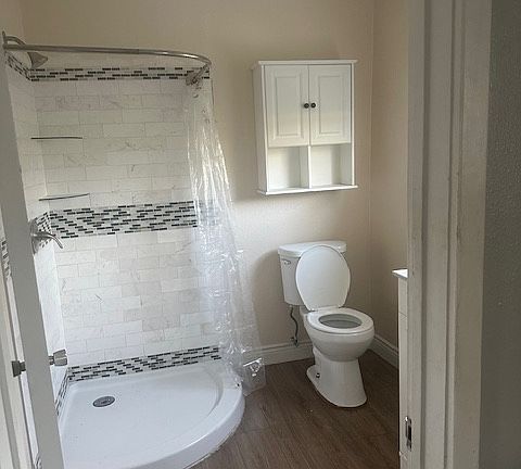 Stand up shower. Cabinet over toilet.
