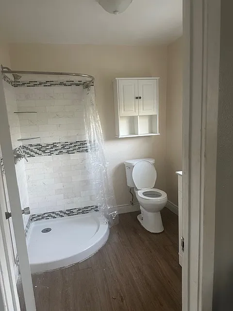 Stand up shower. Cabinet over toilet.