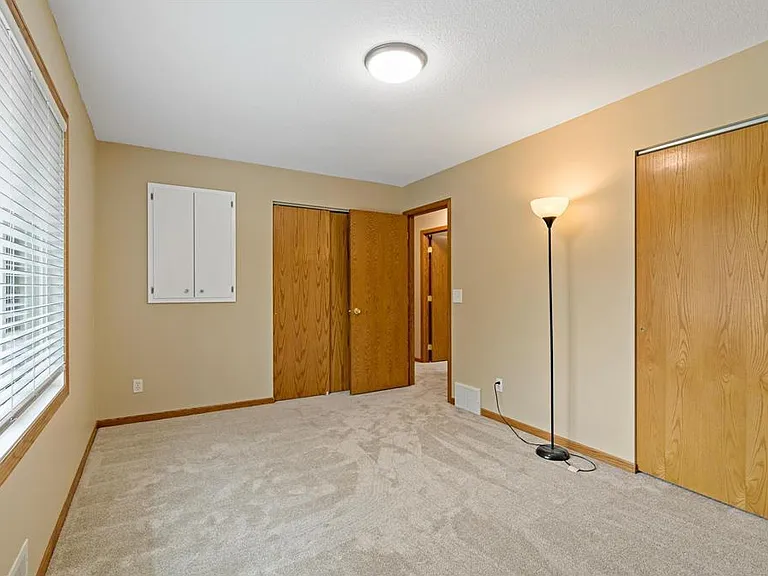 Primary bedroom with two large closets, new carpet, and fresh paint