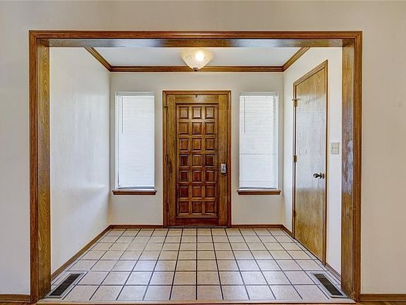 The foyer is a welcoming space to shake off the outdoors and greet your friends. There's room for a bench or displaying art!