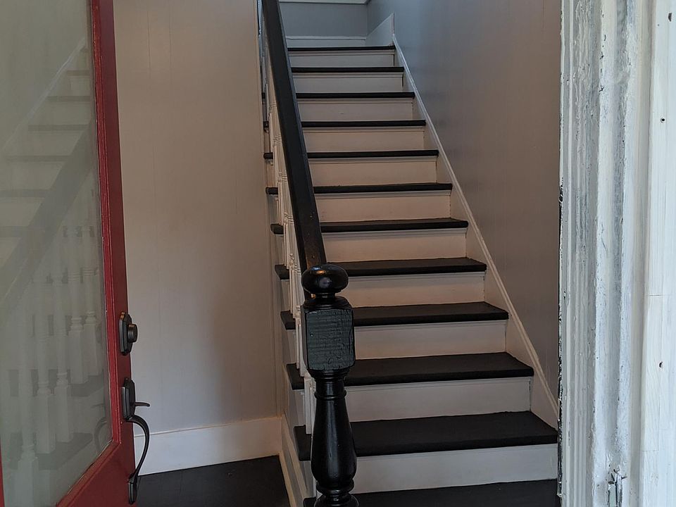 Freshly painted stairs and large entry space for bike storage.
