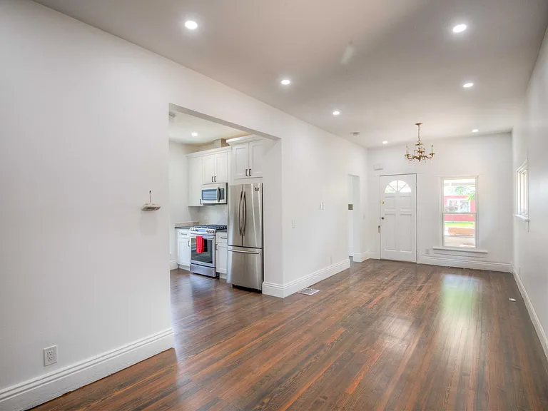View into kitchen from opening between living room and dining room.