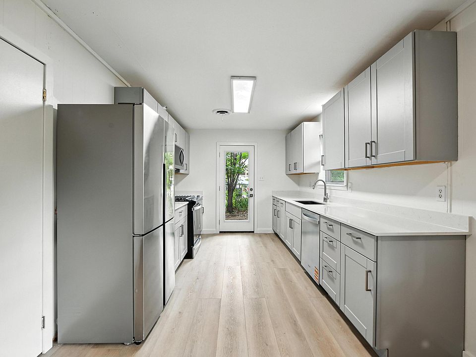Kitchen has new shaker cabinets, quartz countertops, and new stainless steel appliances