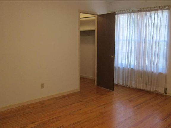 View of the pretty hdwd. flooring in Master BR which overlooks the patio. Walk-in closet plus another closet in this bedroom. Door to master bath is to the left.