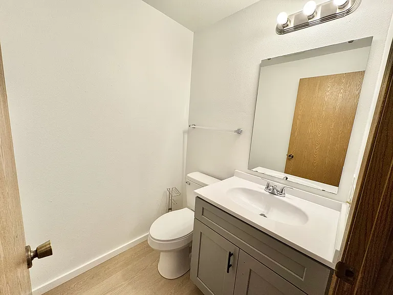 Convenient half bath on main level with new cultured marble counter and new shaker vanity.
