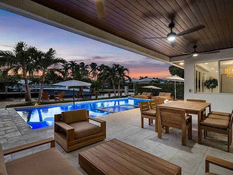 End your day poolside with cozy seating, ambient lighting, and serene water views.