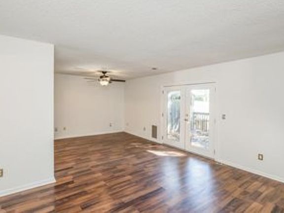 Spacious living room / den / office area, separate dining area on left