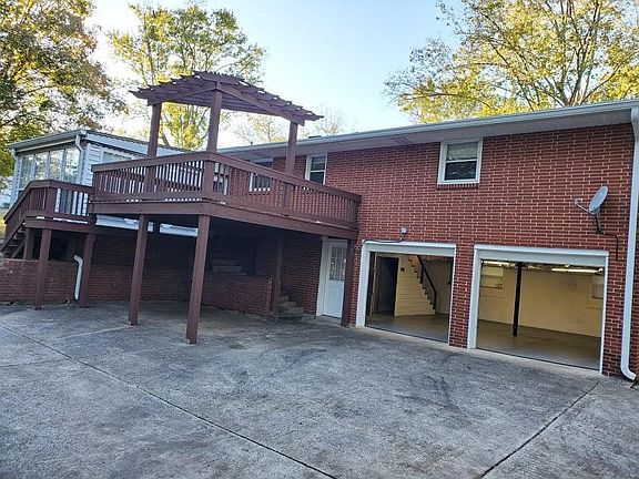 Back of the home. Nice deck and attached rear entry two car garage. Additional parking under the deck.